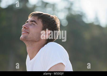 Young man with pure happiness on his face admiring sun Stock Photo