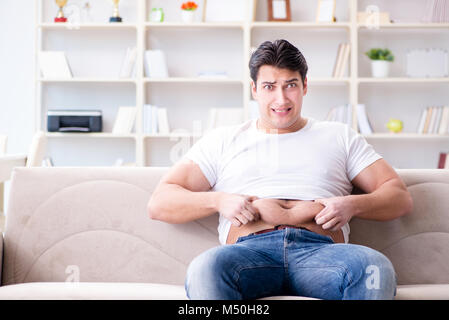 Man suffering from extra weight in diet concept Stock Photo