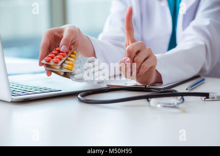 Doctor with prescribed medicines in medical concept Stock Photo