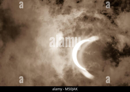 Partial Solar Eclipse Through Clouds Stock Photo