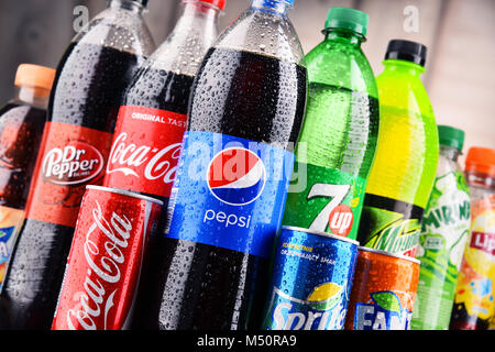 Bottles and cans of assorted global soft drinks Stock Photo - Alamy