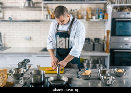 chef preparing dough for pasta on kitchen Stock Photo