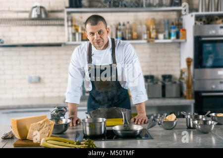 Friendly cook is situating in airy kitchen. cook preparing to cook ravioli Stock Photo