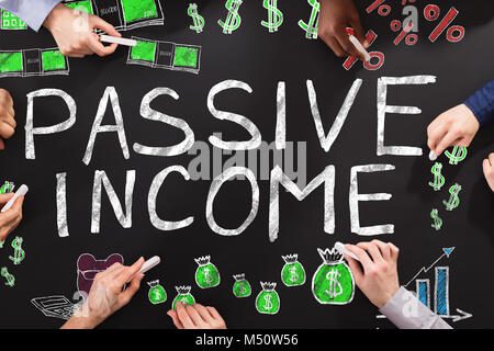 People Drawing Passive Income Concept On Blackboard Stock Photo
