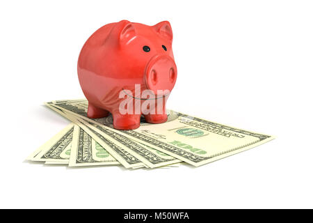 a red piggy bank over dollar notes Stock Photo