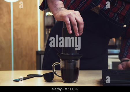 Barista brewing aeropress coffee Stock Photo