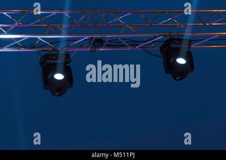 Stage lights on concert. Lighting equipment with white beams. Stock Photo