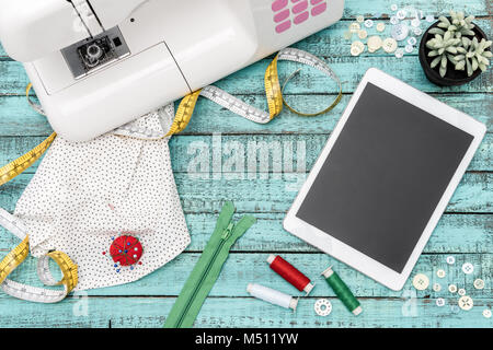 digital tablet and tailoring items on table Stock Photo