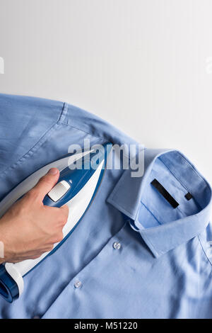 man ironing shirt Stock Photo