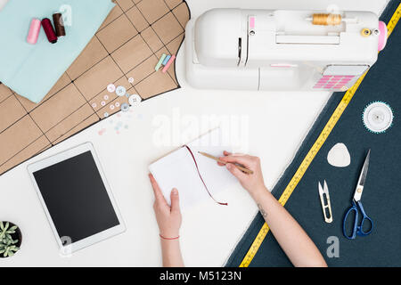 tailor writing in notebook Stock Photo