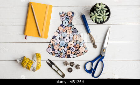 dress made of buttons and tailoring items Stock Photo