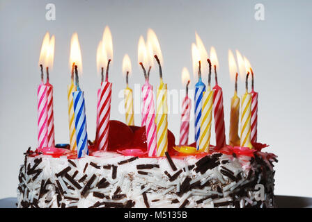 a birthday cake with lighted candles Stock Photo