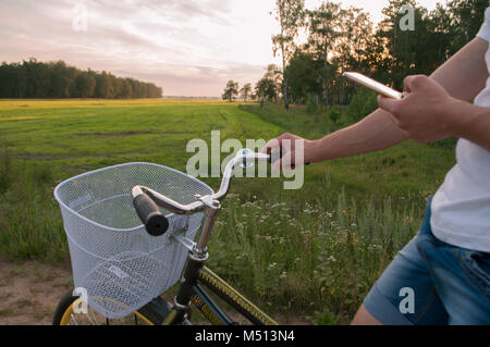 Cyclist using Navigator on your smartphone, search GPS coordinates during Cycling. active lifestyle and modern technology. Stock Photo
