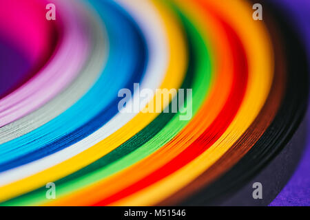 close up of colored bright quilling paper stripes on purple Stock Photo