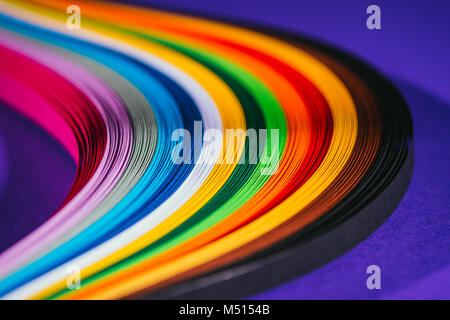 colored bright quilling paper stripes on purple Stock Photo