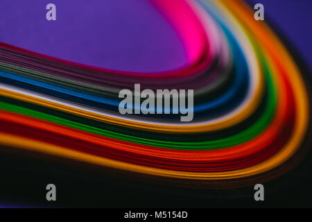 colored bright quilling paper stripes on purple Stock Photo
