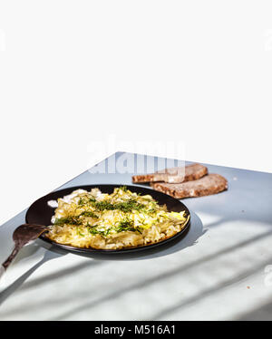 Healthy breakfast. Stewed Vegetables and eggs in a frying pan Stock Photo
