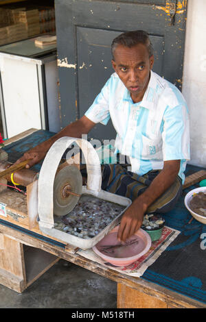 GALLE, SRI LANKA - JANUARY 24, 2014: Unindentified man doing traditional gem ppolishing in Galle, Sri Lanka. The gem and jewellery industry has been a Stock Photo