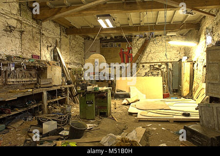The inside of an old fashioned ship builders workshop, with tools and wooden templates scattered around. Stock Photo