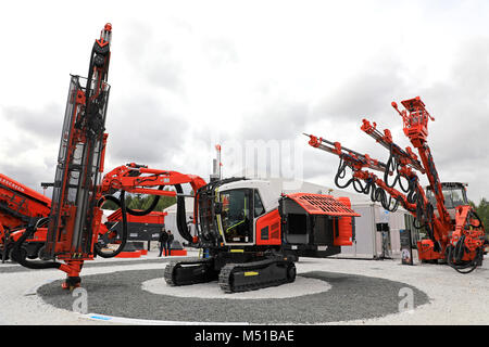 HYVINKAA, FINLAND - SEPTEMBER 8, 2017: Sandvik mining equipment, in the center Ranger DX800i surface top hammer drill rig and right, 3-boom tunneling  Stock Photo