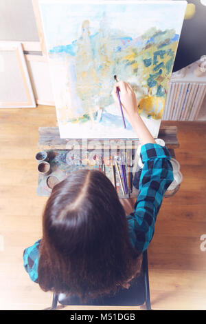 Teenage lady painting on art canvas Stock Photo