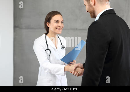 Extract from the hospital. The doctor gives the patient the results of the tests. Stock Photo