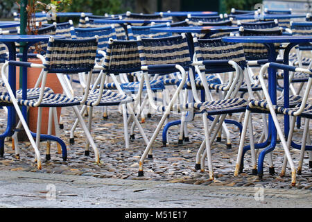 Empty chairs in outdoor cafe outside garden Stock Photo