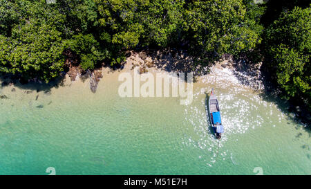 Top view of  wooden boat and blue sea of the Andama sea island photo with outdoor sun lighting from drone. Stock Photo