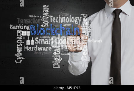 Blockchain Cloud is written by businessman on screen. Stock Photo