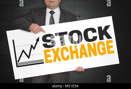 Stock exchange poster is held by businessman. Stock Photo