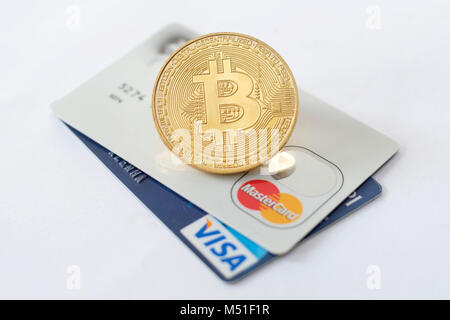 Bitcoin token on top of VISA and MasterCard credit cards Stock Photo