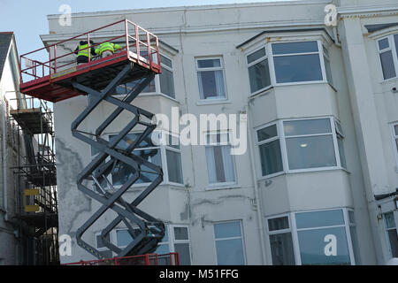 Two men working on a block of flats. Stock Photo