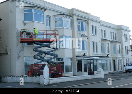 Two men working on a block of flats. Stock Photo