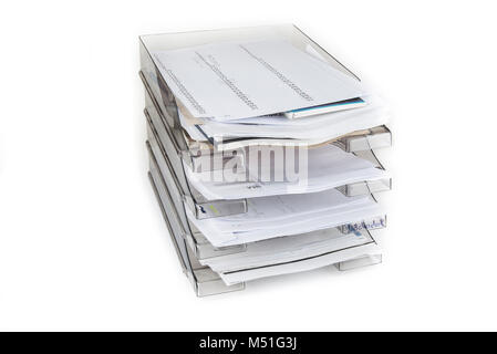 Desktop filing drawers full of papers on the white. Paper office tray. Stock Photo