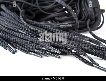 Black spare shoe laces on the white background Stock Photo