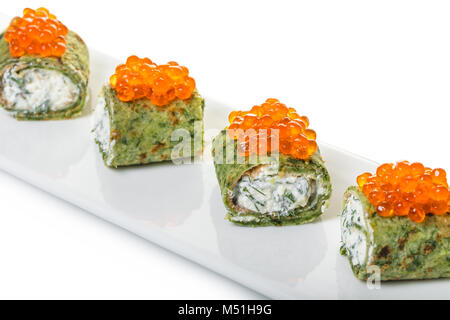 pancakes with spinach and red caviar on white background Stock Photo