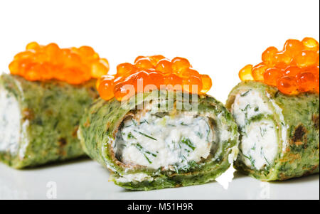 pancakes with spinach and red caviar on white background Stock Photo