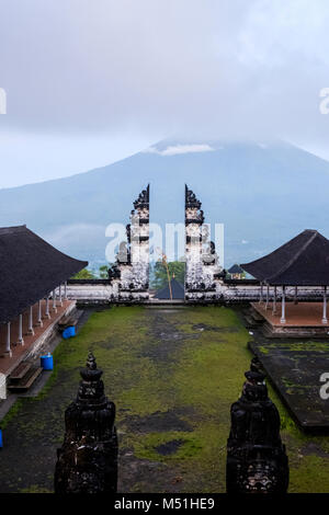 Balinese split gateway ('candi bentar') and outer sanctum, with Mt. Agung in the distance, Pura Lempuyang temple, Bali, Indonesia. Stock Photo
