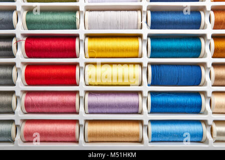 Sewing threads multicolored background closeup Stock Photo