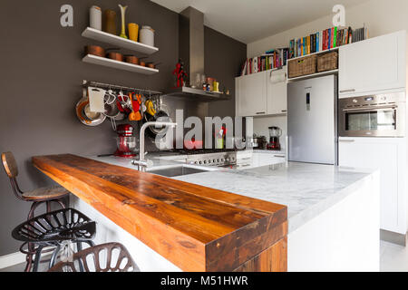 A beautiful modern kitchen equipped with a variety of kitchen equipment and cook books Stock Photo