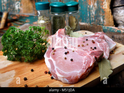 Fresh pork chops with spicy ingradient set in the kitchen with indoor flash lighting. Stock Photo