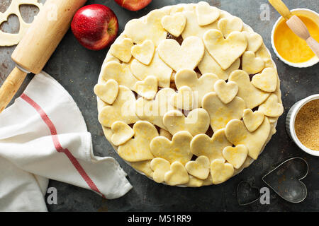Making apple pie from scratch with heart shaped crust Stock Photo