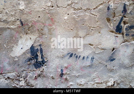 old grey concrete garage wall with spots of black paint abstract background Stock Photo