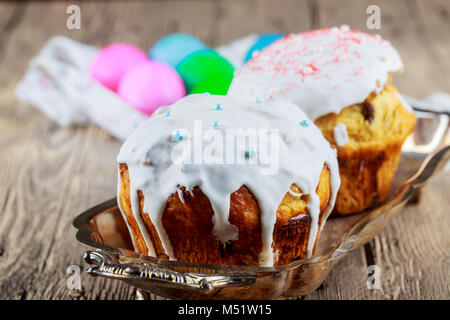 Easter composition of sweet bread, paska, willow twigs and eggs on light wooden background. Orthodox kulich. Holidays Stock Photo