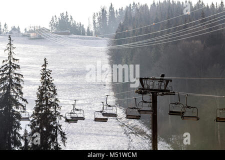 Ski lift with empty seats over the snow mountain in ski resort Stock Photo