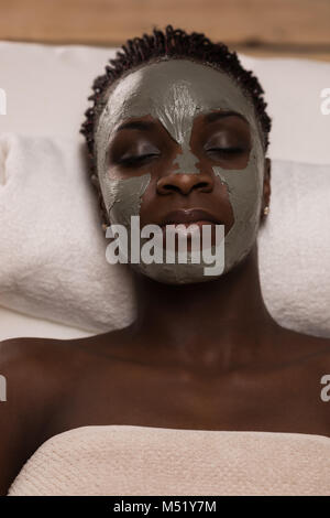 African beauty woman getting mud mask at spa Stock Photo