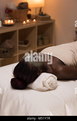 African beauty woman getting mud mask at spa Stock Photo