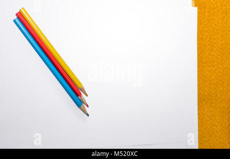 Colorful crayons on white paper Stock Photo