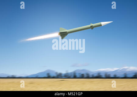 nuclear rocket bomb flying over a landscape field Stock Photo