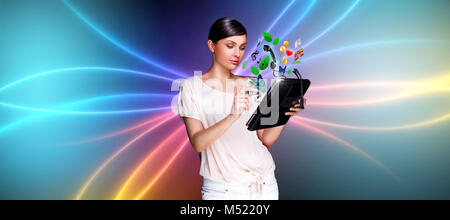 Young pretty woman using her universal device Stock Photo